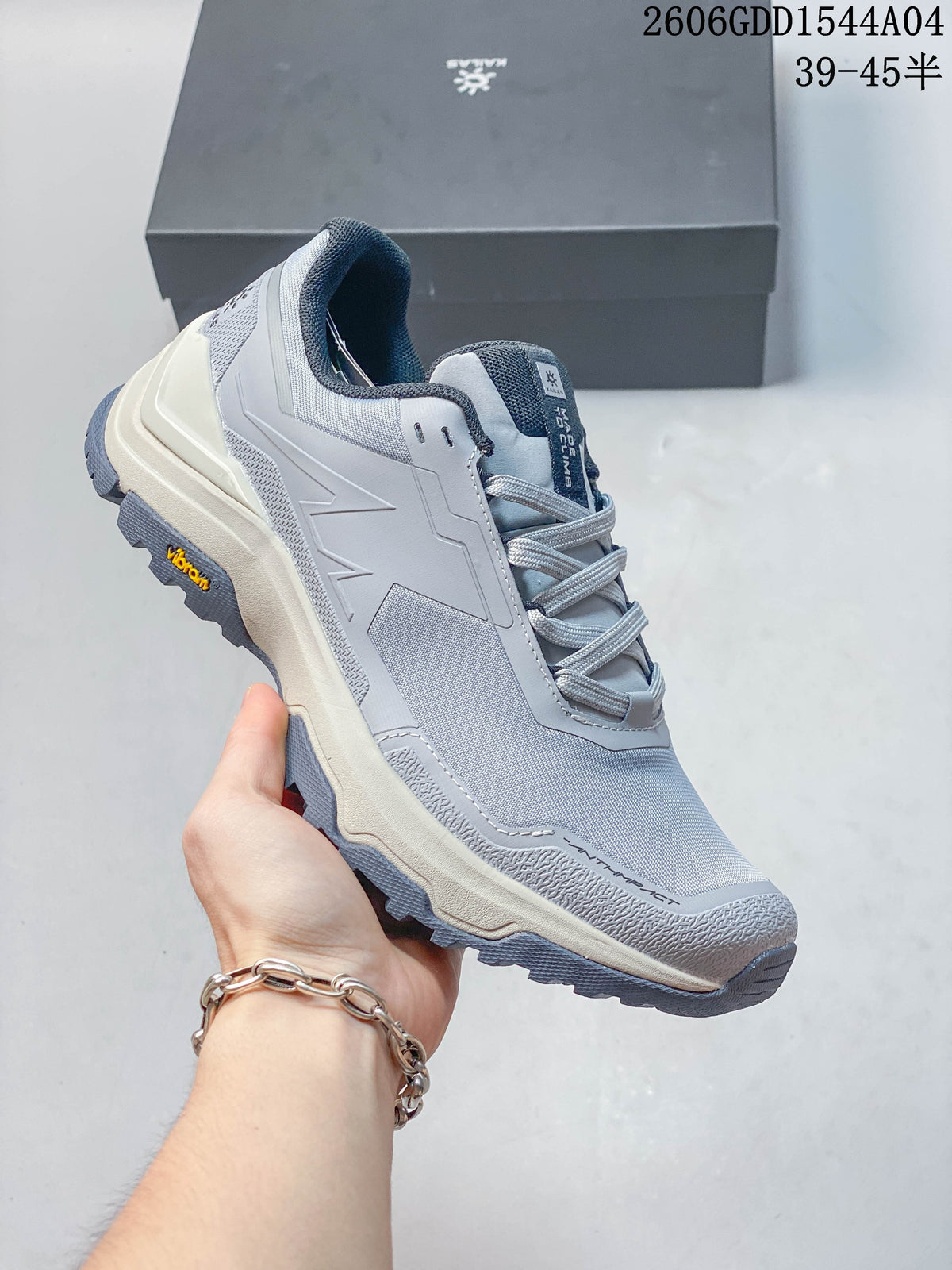 Angled side view of a light grey KAILAS hiking shoe with a lugged outsole.