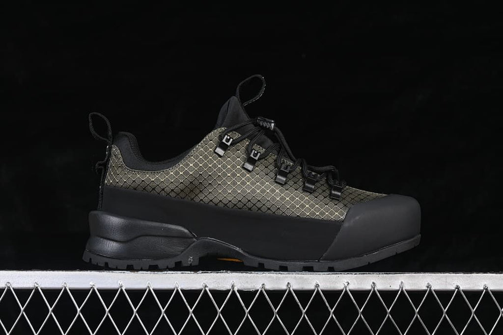 Side profile of the low-cut shoe with patterned upper and black overlays