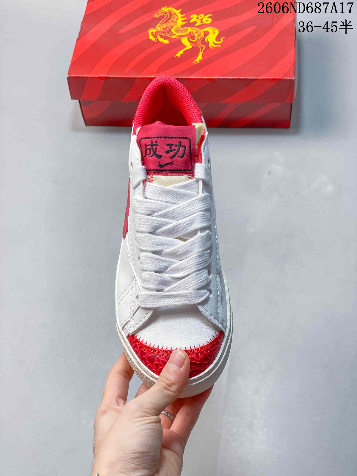 Front view showing white laces, red patterned toe accents, and a red padded collar.