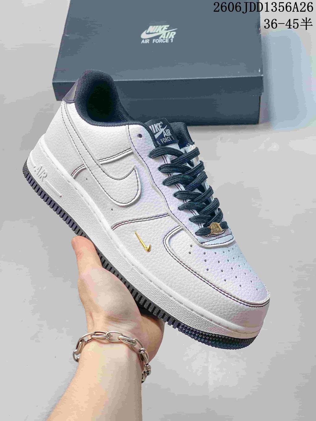 White Nike Air Force 1 low-top sneaker with dark laces and contrasting details