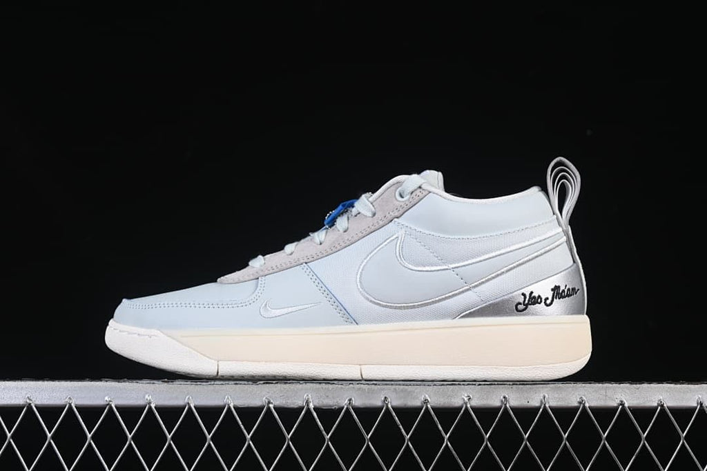 Side profile of the light gray Nike Book 1 shoe