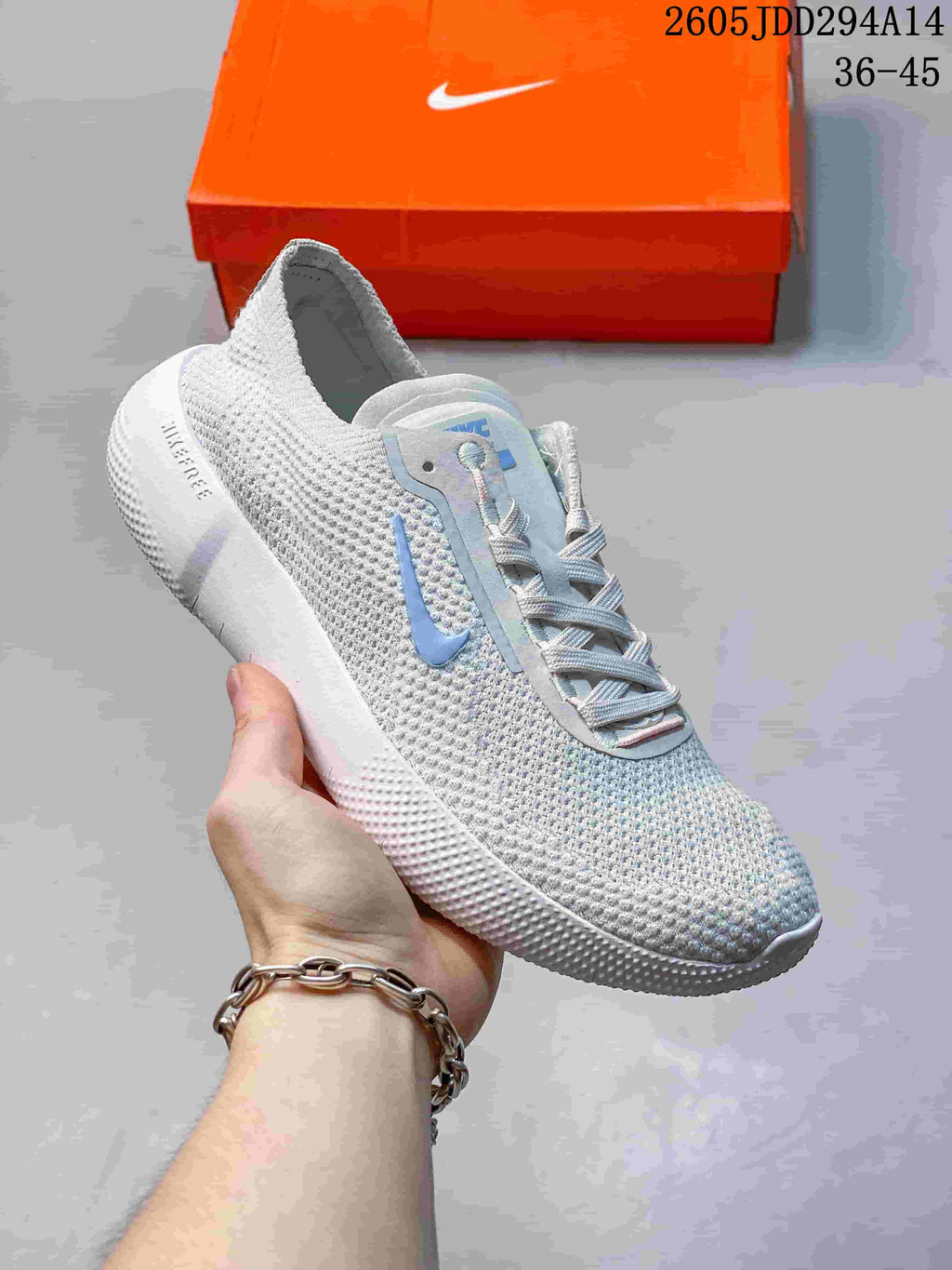 White Nike Free low-top sneaker with pale blue accents.
