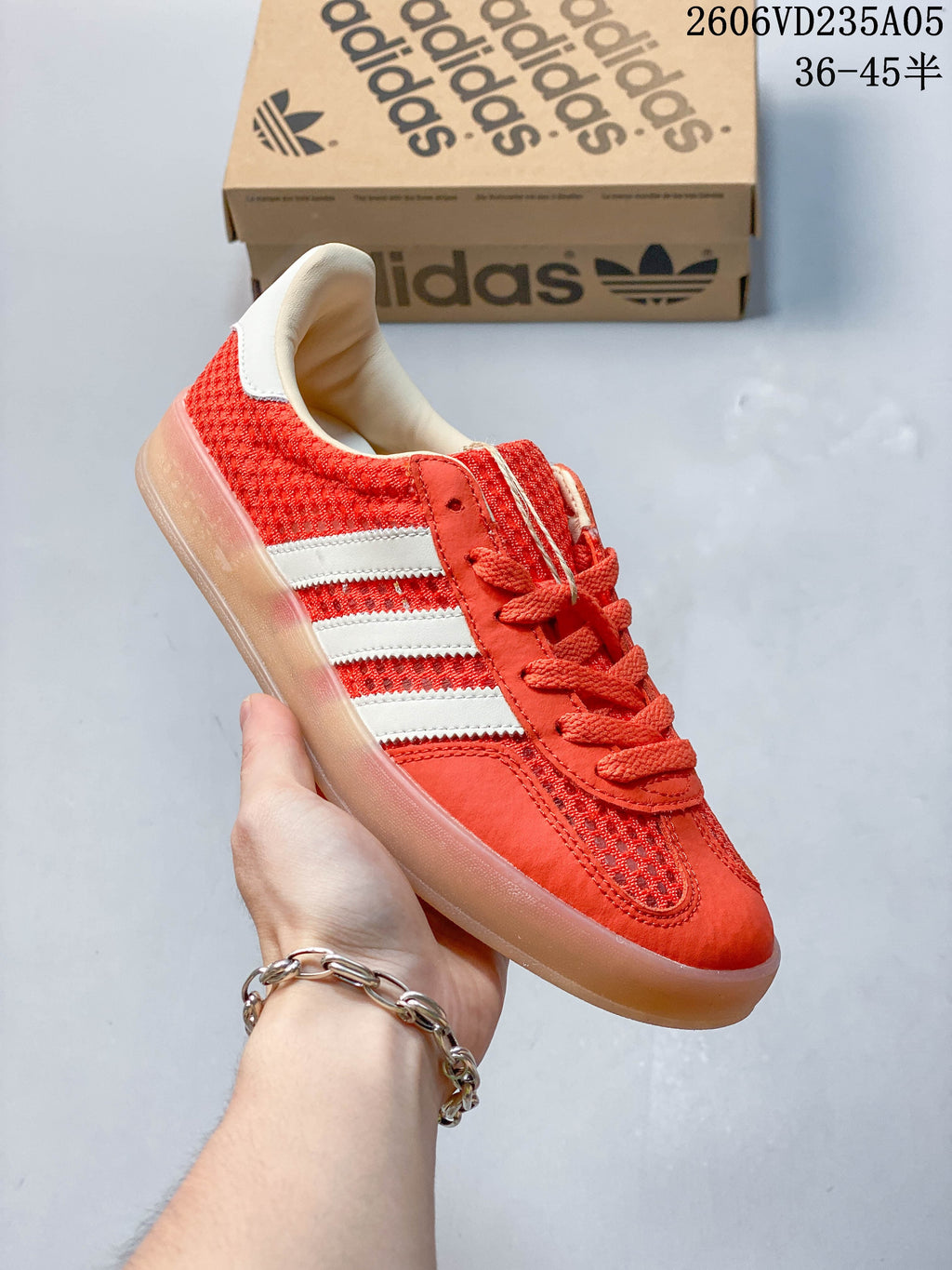 Side view of the red sneaker with white stripes and translucent outsole