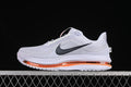Side view of light gray Nike Air Zoom Pegasus Premium shoes with orange sole accents