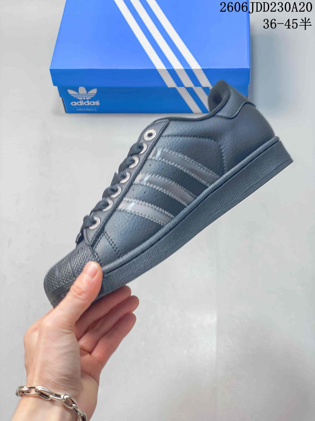Side profile showing the stripes, shell toe, and low-top shape