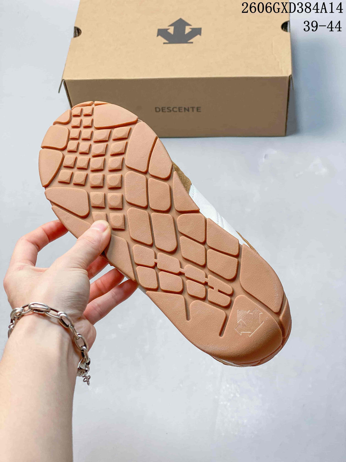 Close-up of the patterned brown outsole on a Descente sneaker