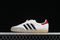 Side profile of white adidas Samba OG sneakers with black stripes, gray toe overlay, red heel detail, and gum outsole