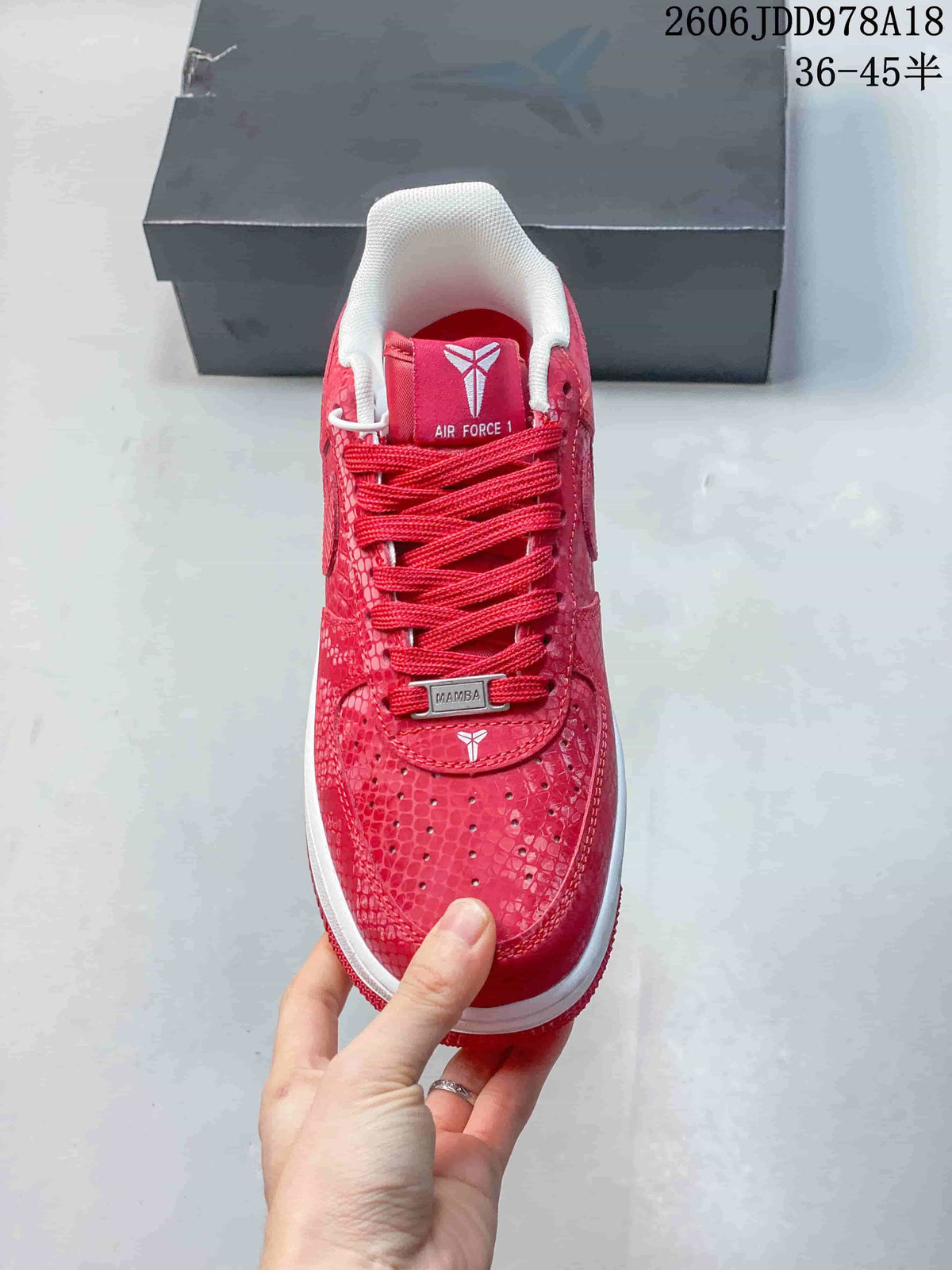 Front view of the red patterned sneaker showing its laces and perforated toe