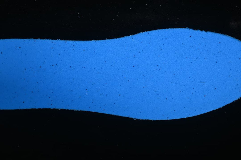 Blue-lit close-up of the sneaker's outsole