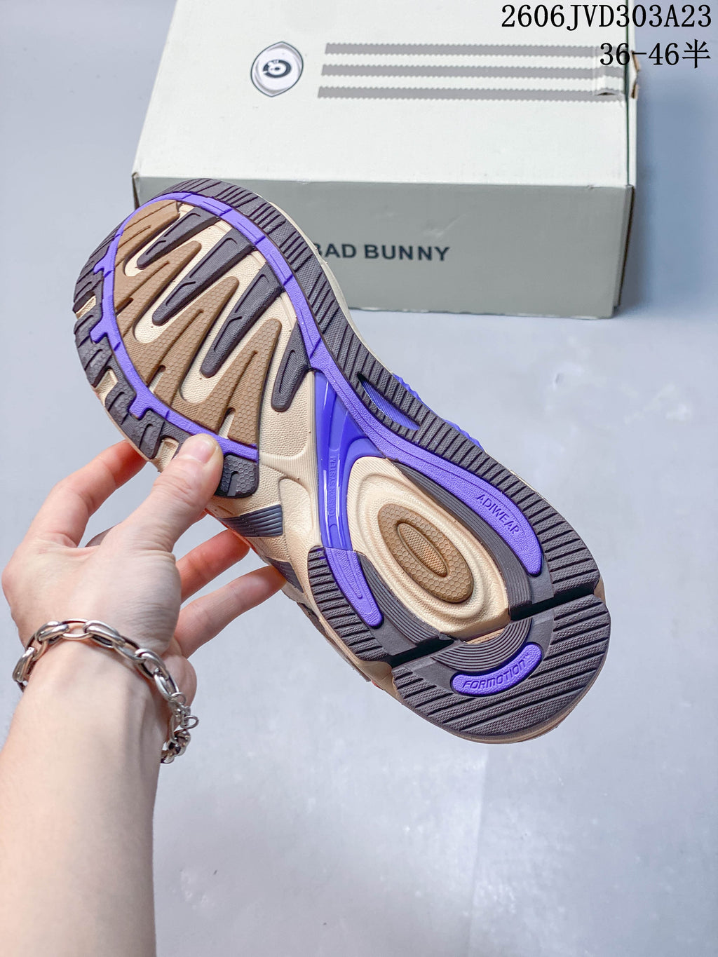 Underside view showing the segmented outsole and purple accents