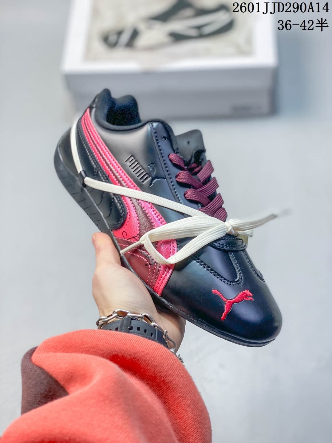 Side view of a navy PUMA Speedcat TTF sneaker with pink side stripes and decorative cream laces.