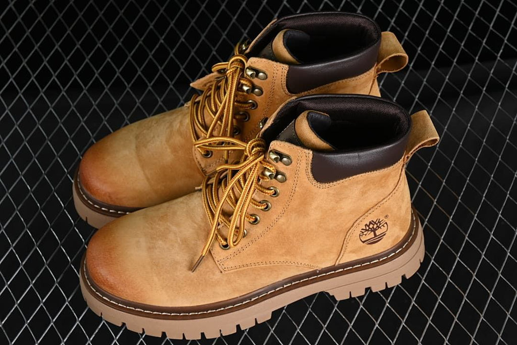 Pair of wheat-brown mid-top lace-up boots shown from above