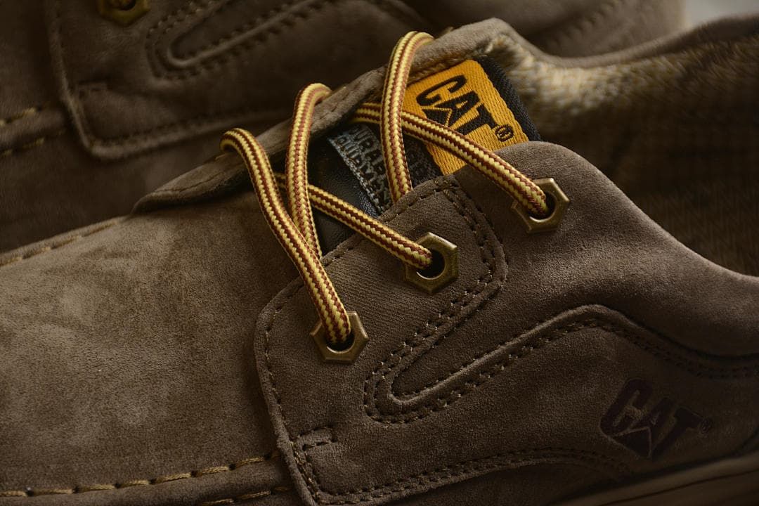 Close-up of CAT branding, contrast laces, and metal-tone eyelets