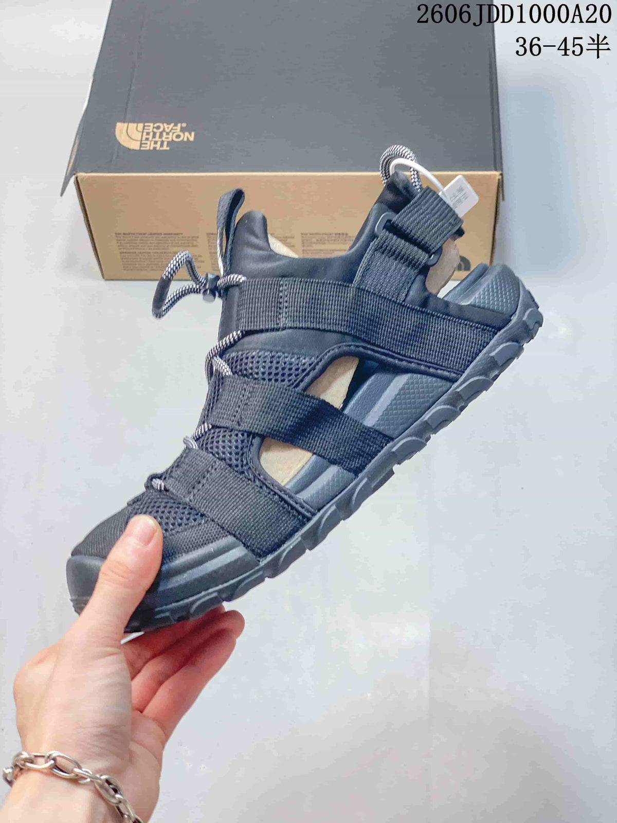 Side view of a dark navy Cedar Measa sandal with mesh panels and webbing straps