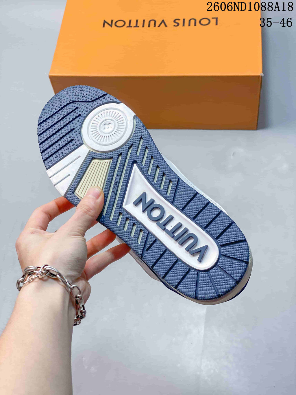 Close-up of the blue patterned outsole with a central logo panel