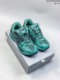 Pair of teal and dark gray ASICS GEL-KAYANO 14 sneakers on a shoebox; image text shows 36–45 and 2412JYD320A09.