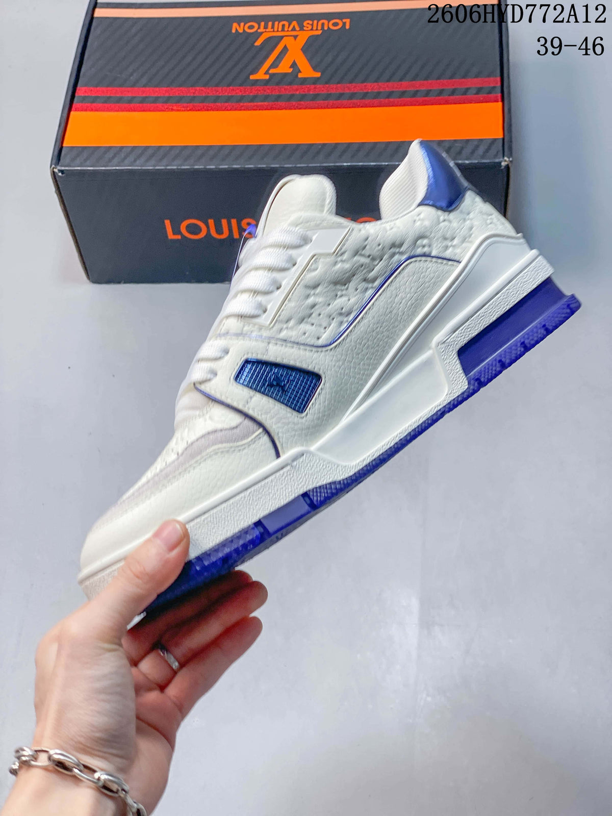 Side view of the white sneaker with blue accents and textured panels