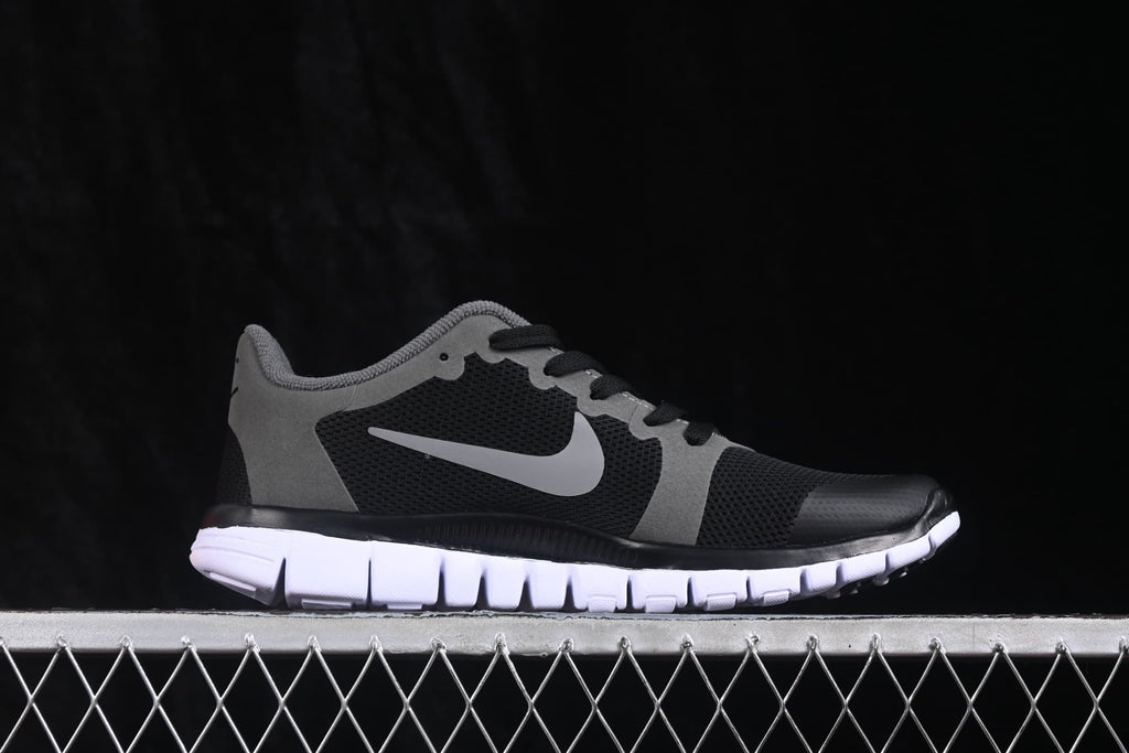 Opposite side profile of the black and grey Nike Free 3.0 sneaker.