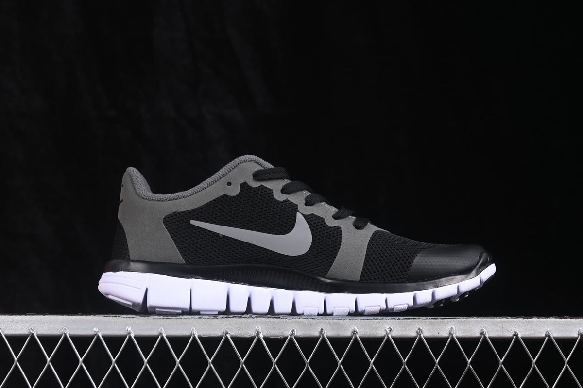 Opposite side profile of the black and grey Nike Free 3.0 sneaker.