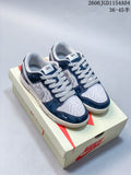 Pair of blue and grey Nike SB Dunk Low sneakers displayed on a box