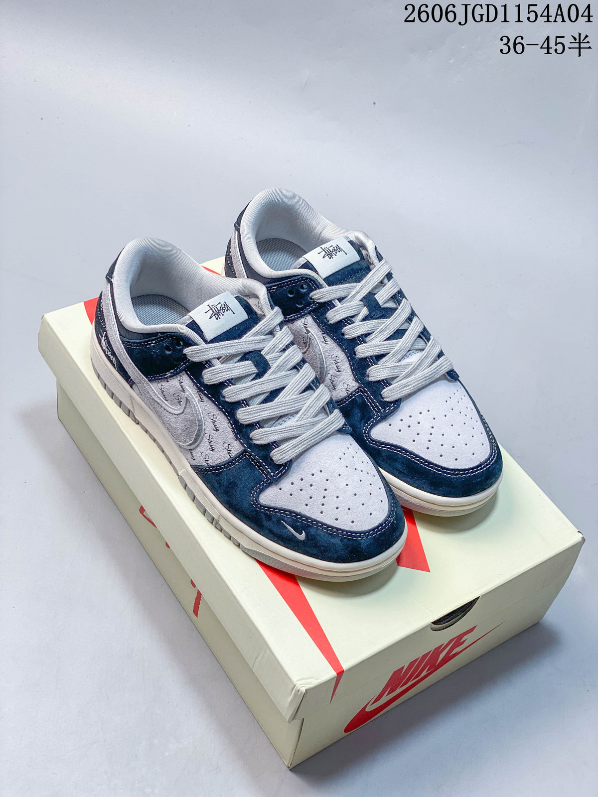 Pair of blue and grey Nike SB Dunk Low sneakers displayed on a box