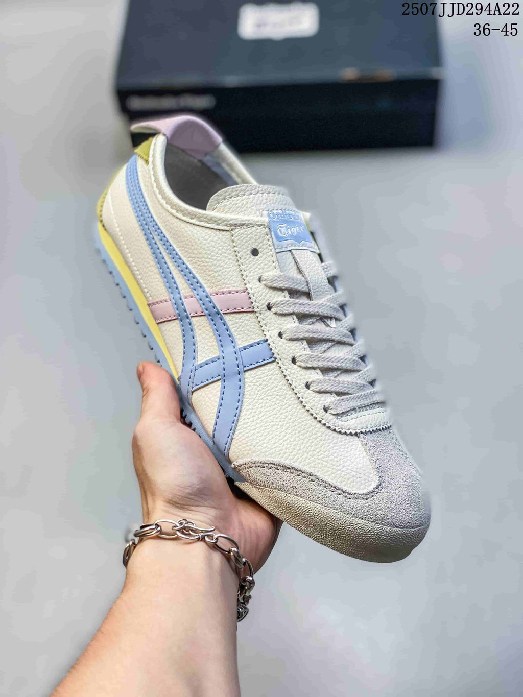 Angled close-up of a cream Onitsuka Tiger sneaker with blue side stripes