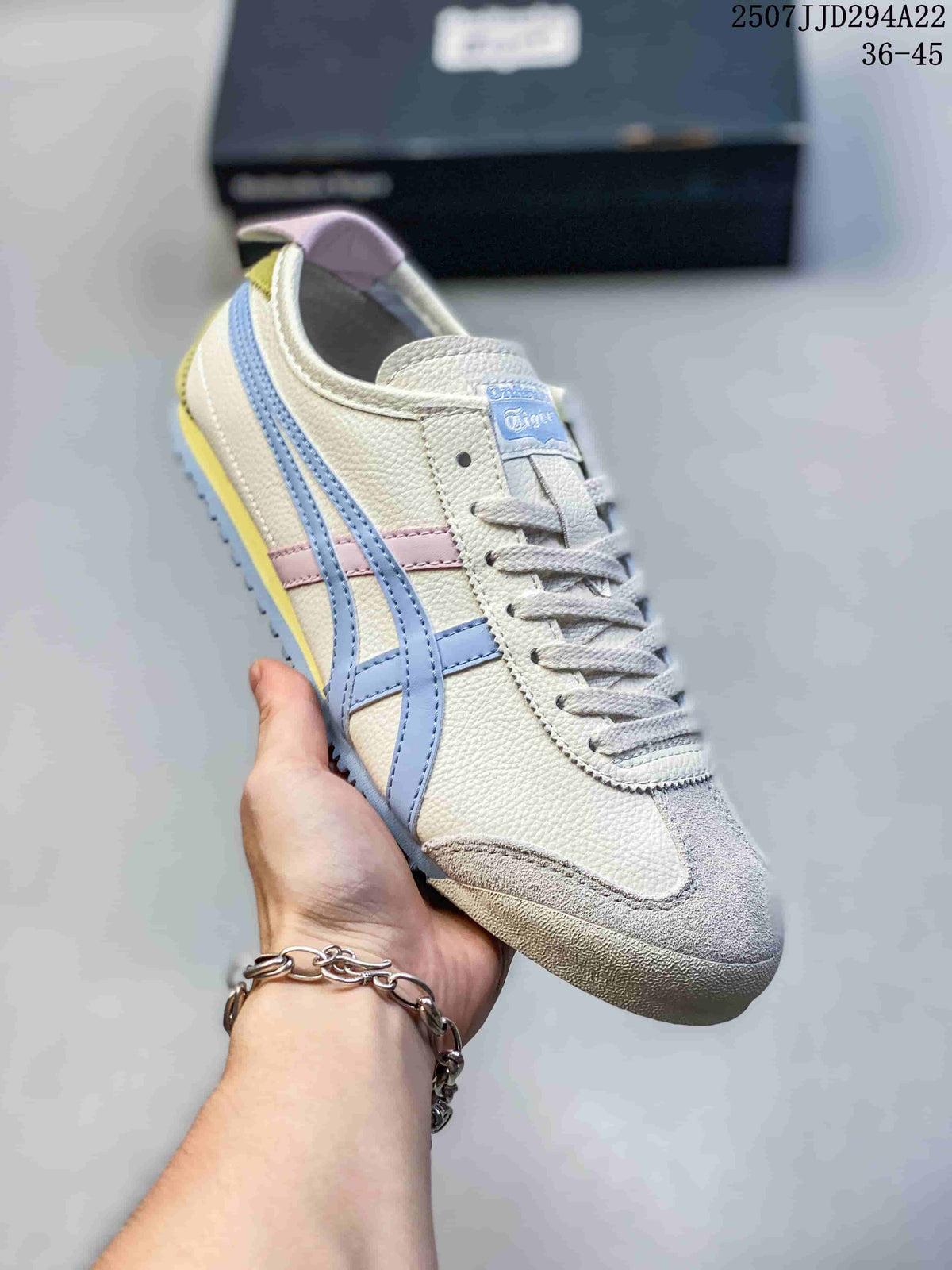 Angled close-up of a cream Onitsuka Tiger sneaker with blue side stripes