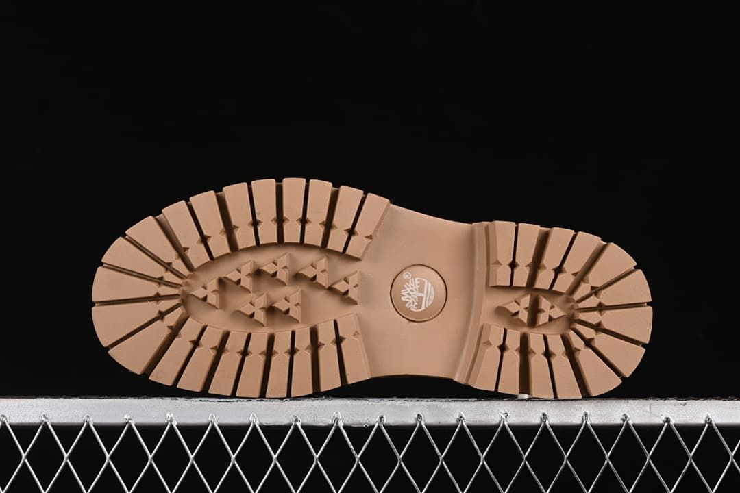 Underside showing the tan lugged outsole tread