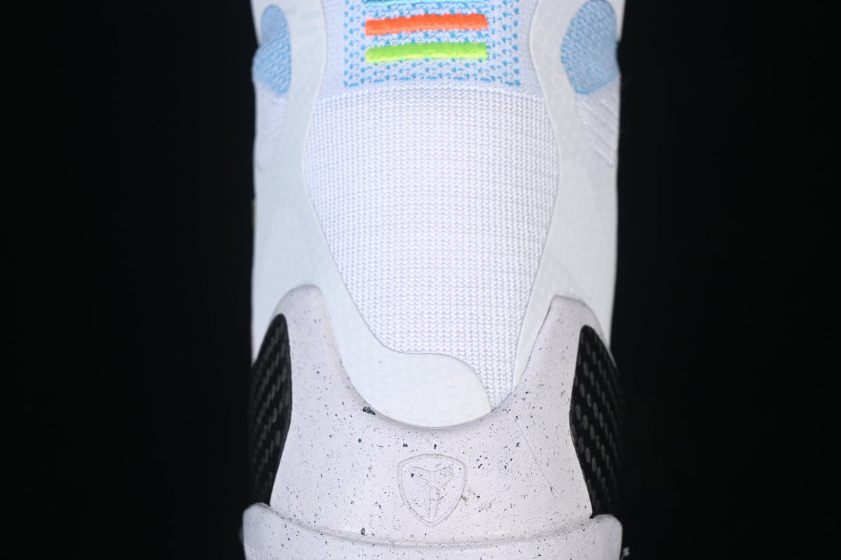 Close-up of the white heel, speckled midsole, and dark heel-side detail.