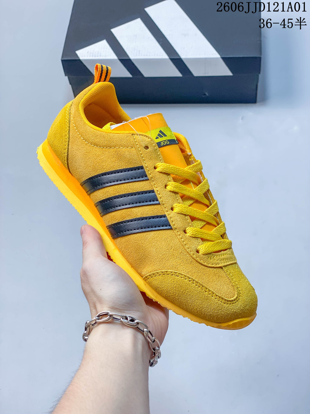 Angled side view of the yellow adidas VS JOG 2.0 sneaker