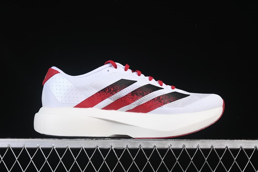 Side profile showing the white midsole and red-black stripes