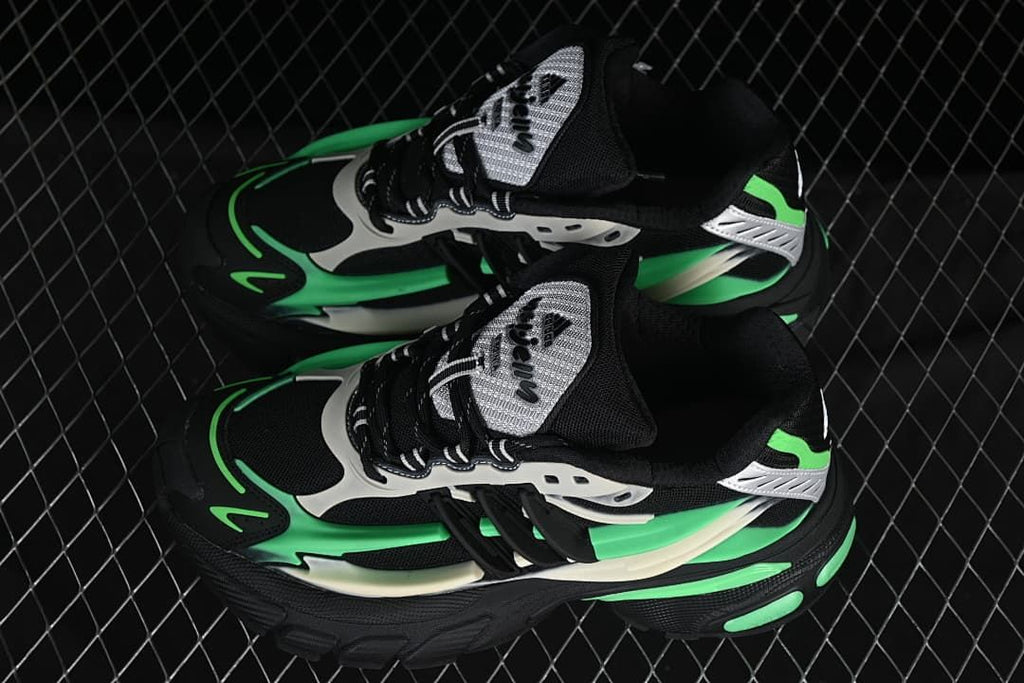 Pair of black, green and off-white Adistar Jellyfish sneakers viewed from above