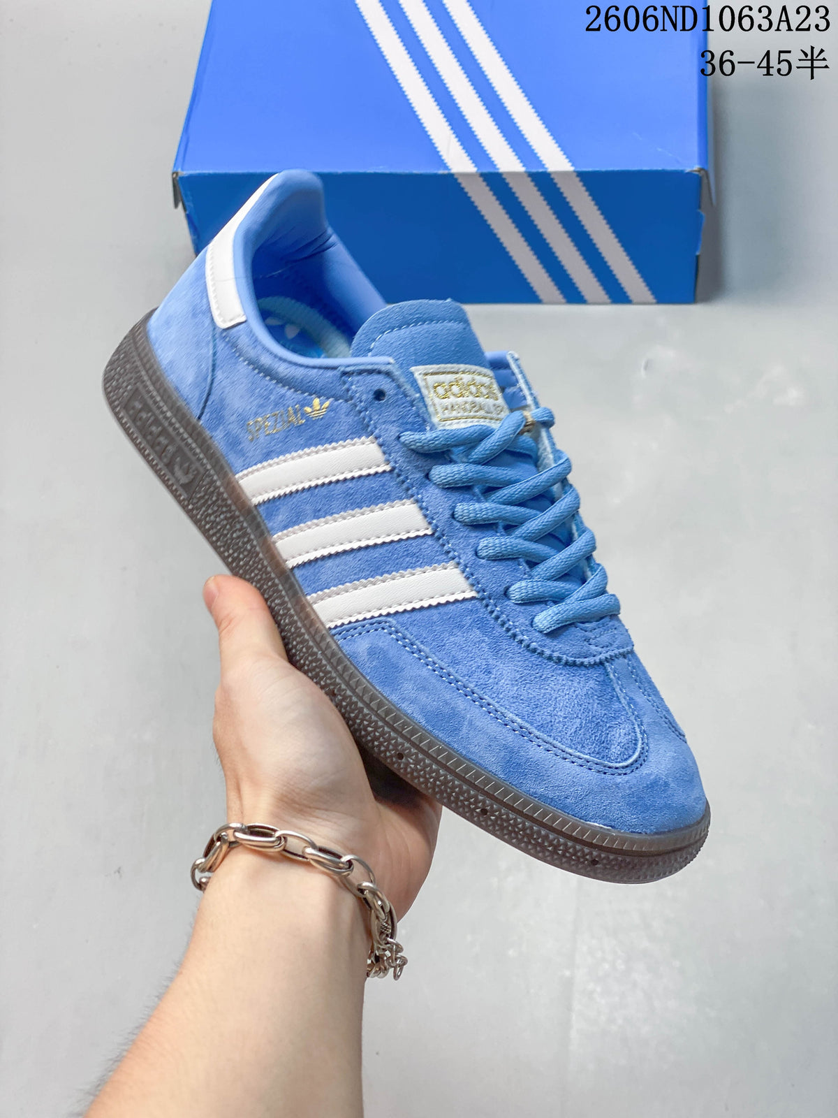 Angled view of the blue sneaker with white stripes and dark textured outsole