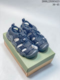 Pair of dark navy KEEN Newport H2 sandals displayed on a box