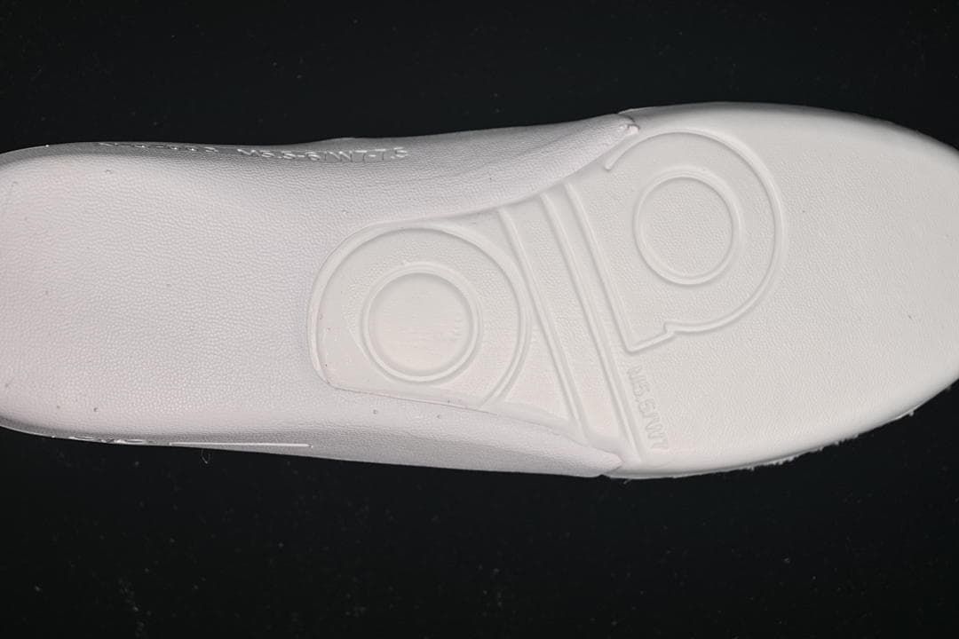 Underside view of the white insole with molded Alo branding