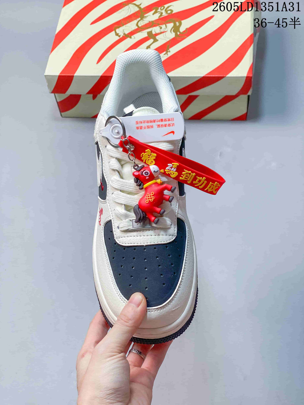 Top view showing the navy perforated toe and horse-themed charm