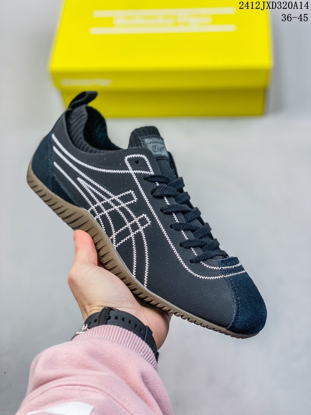 Angled side view of a navy SCLAW sneaker showing its stitched side pattern and textured outsole.