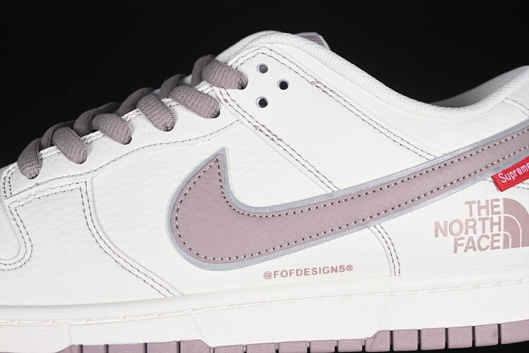 Close-up of the side Swoosh, stitching, and Supreme and The North Face graphics