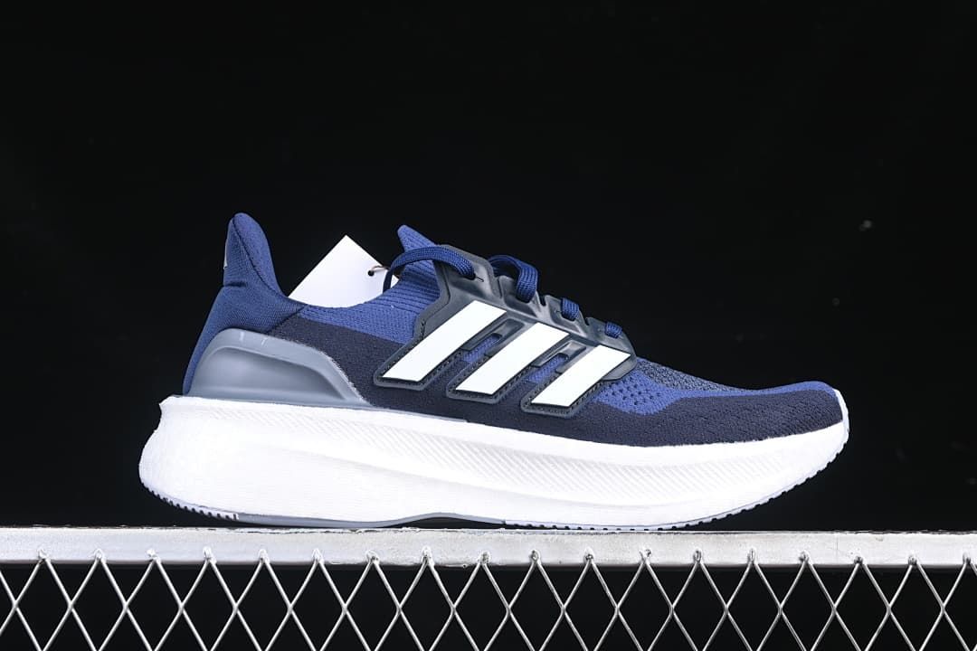 Side profile of the blue shoe with white stripes and white midsole.