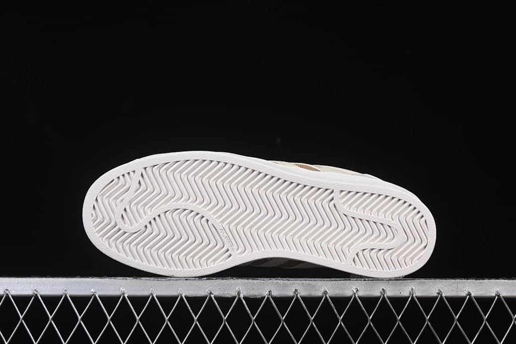 Underside of the white outsole with patterned tread.