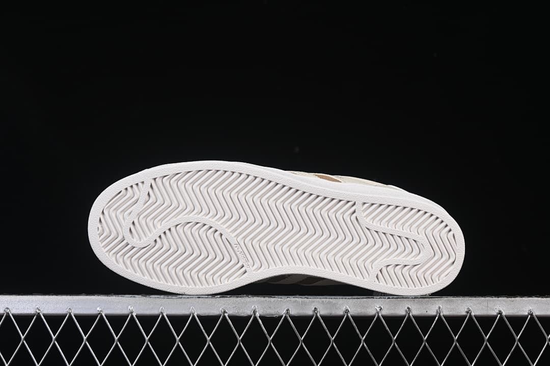 Underside of the white outsole with patterned tread.