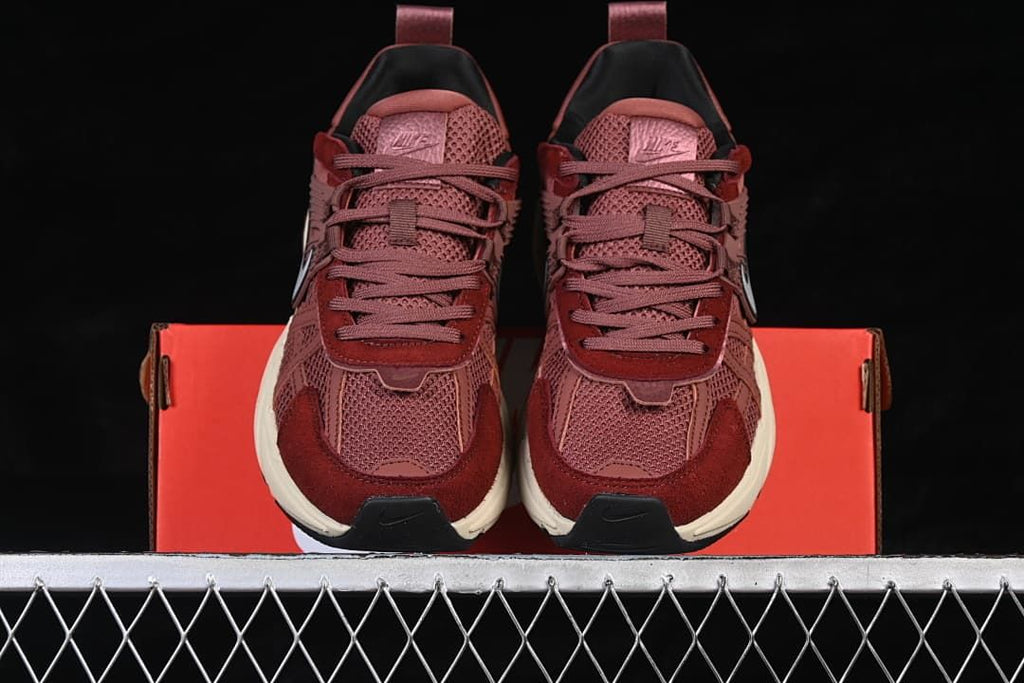 Front view of the pair showing the laces and layered toe panels