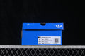 Blue adidas shoebox showing the Superstar II W label, style code JR4234, and a photographed size label.
