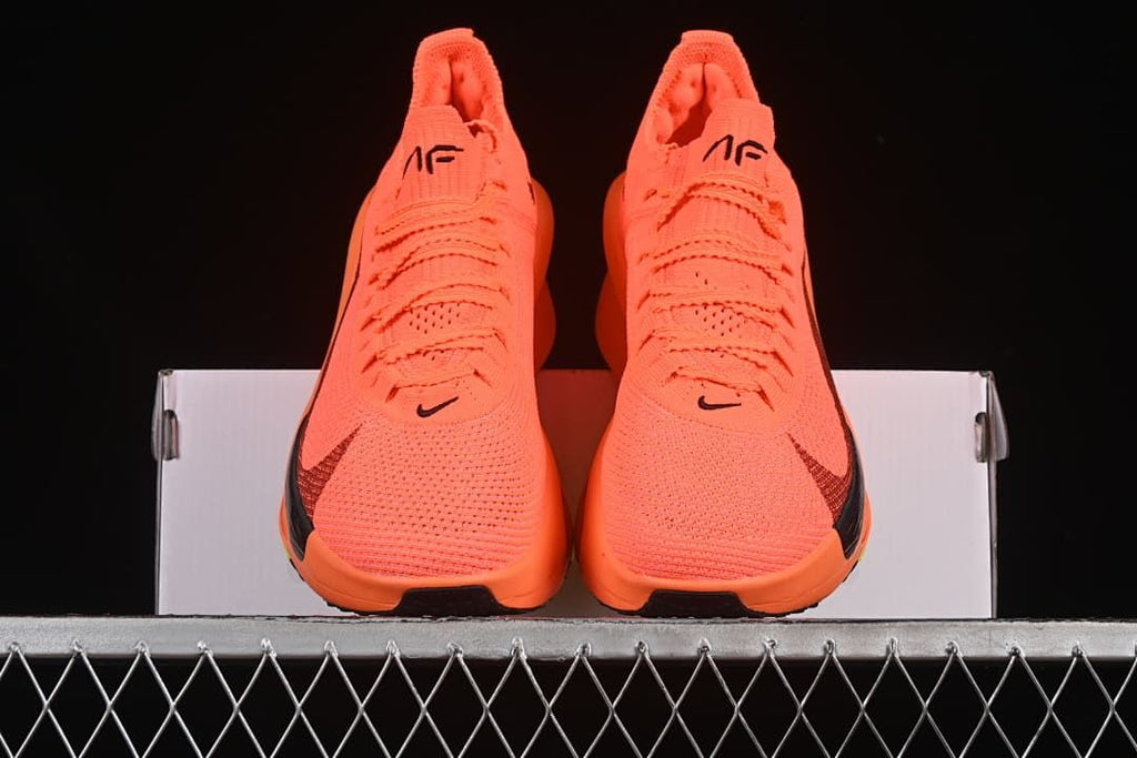 Front view of the pair of orange running shoes