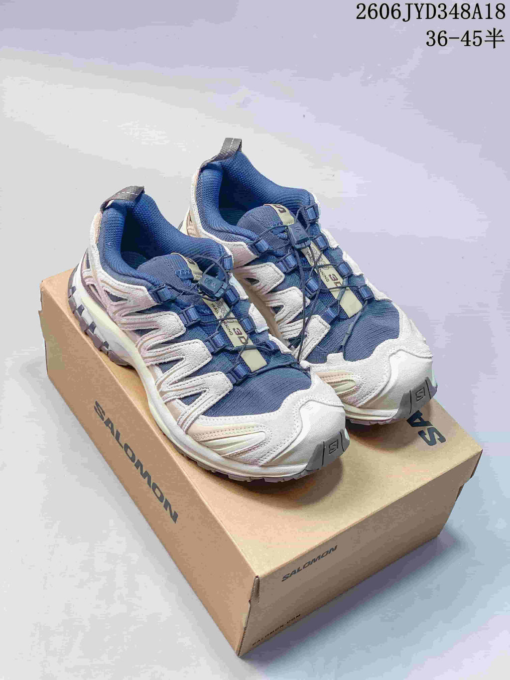 Blue and white Salomon XT-3D trail shoes displayed on a box.