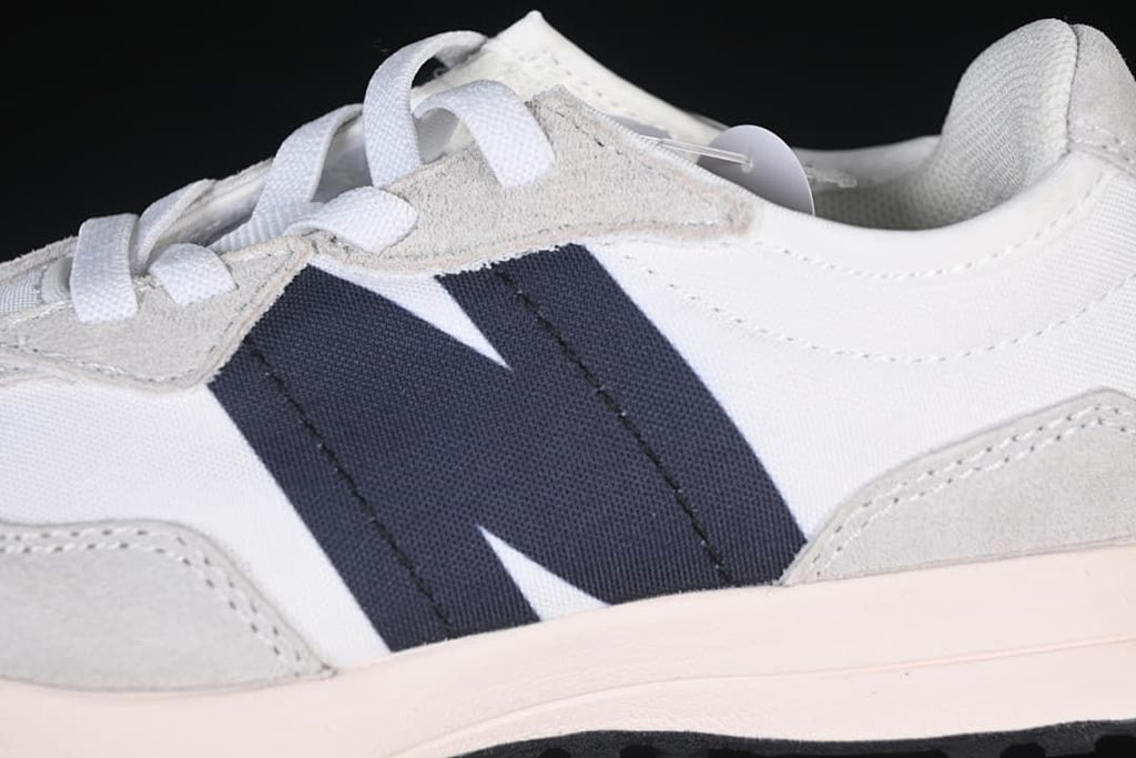 Close-up of the navy side accent, gray overlays, and white upper.