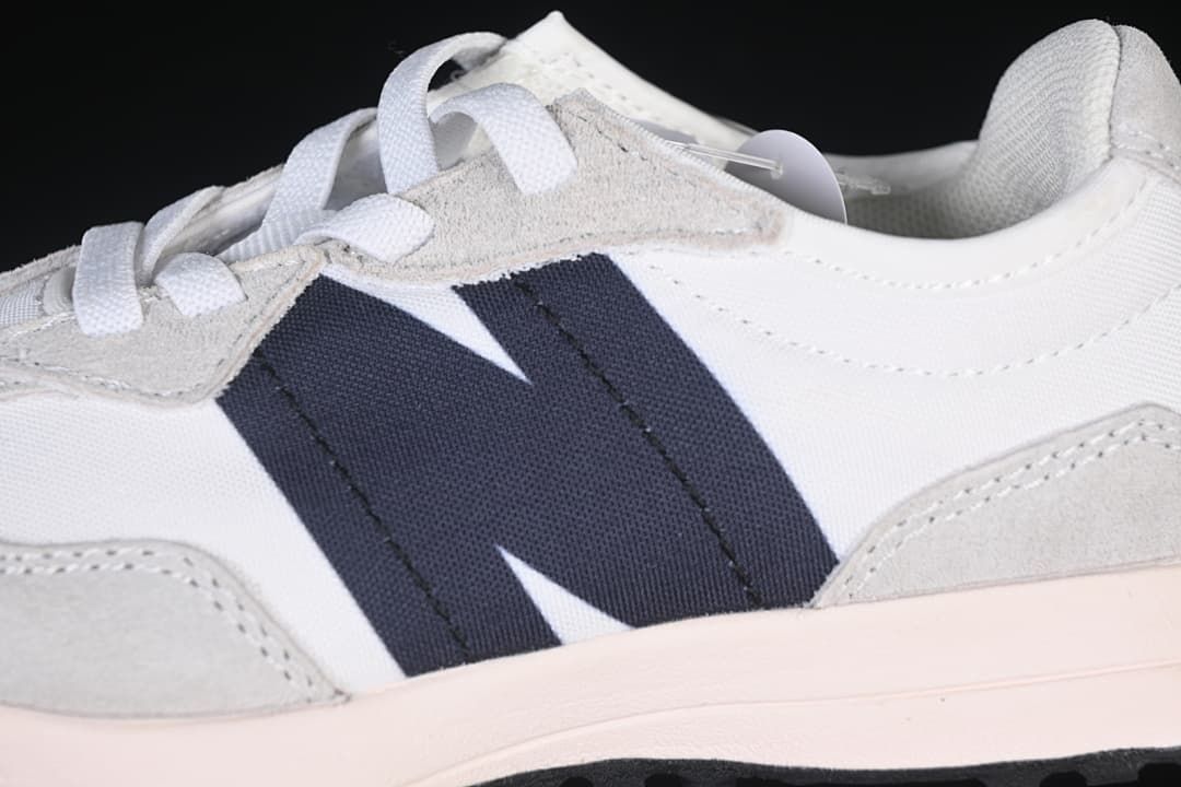 Close-up of the navy side accent, gray overlays, and white upper.