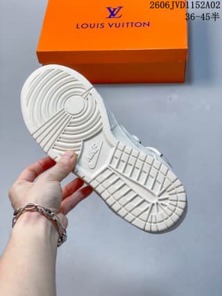 Underside of the white sneaker showing a textured rubber outsole with circular and block tread patterns.