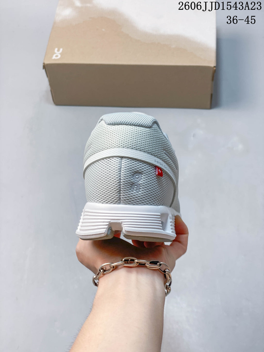 Rear view of a light-colored On Cloudtilt Remix sneaker