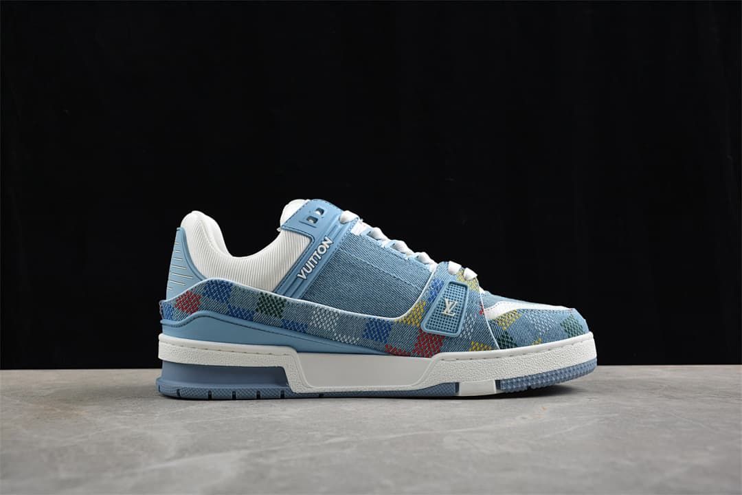 Side profile of the blue and white sneaker with multicolor patterned trim.